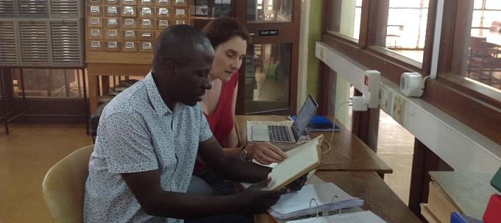 Dr Emma Wild-Wood and research assistant George Mpanga working in the archives at Makerere University, Uganda
