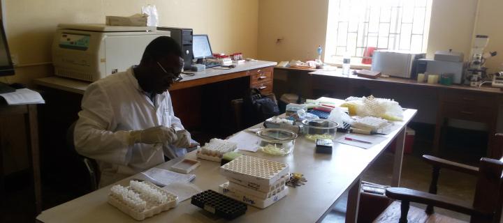 Emmanuel in a lab with samples