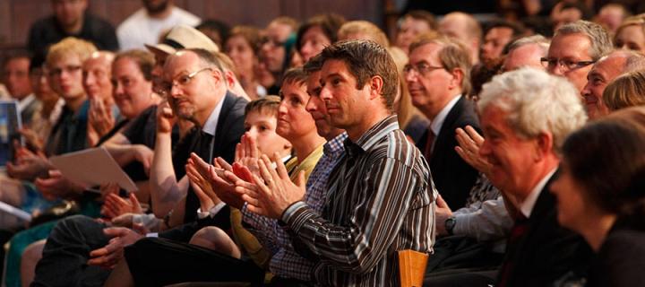 Audience applaud at a lecture