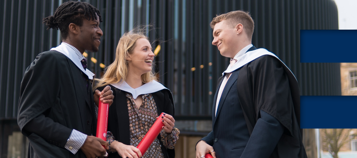 3 students smile and talk wearing graduation gowns. E in colour blocks on right