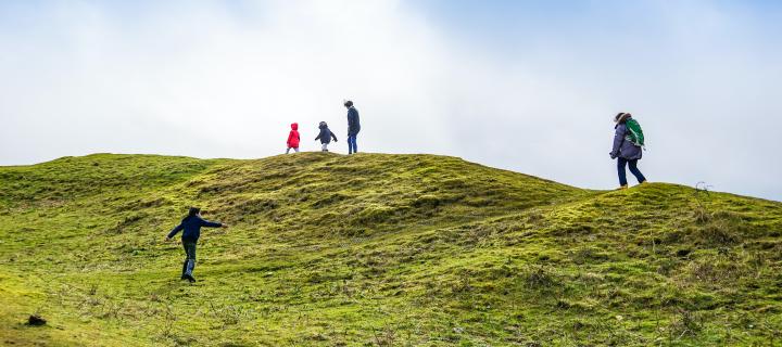 Group of people walking up Scottish hill
