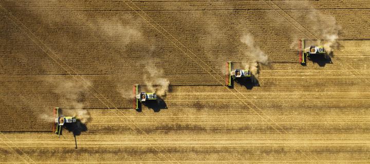 Aerial view of combine harvesters operating in a field