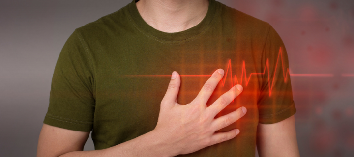 Man with hand on heart with ECG line superimposed