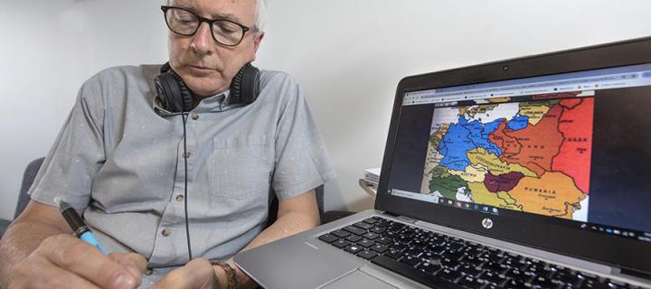 Man wearing headphones using virtual learning environment