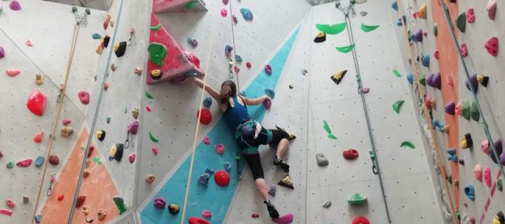 Photo of a person on a climbing wall