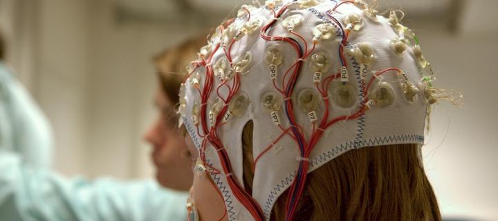 Girl connected with cables for EEG for a scientific experiment