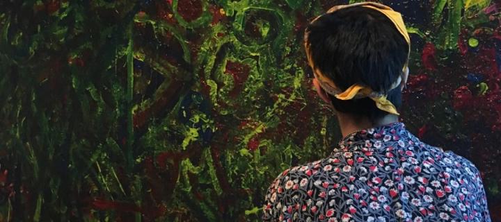 A photo of Jessica Cox viewing a painting in Montreal