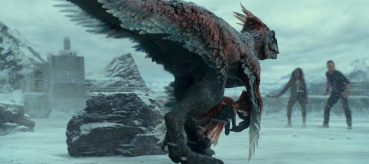 Image from the movie Jurassic World , where a feathered dinosaur stalks two people in the snow