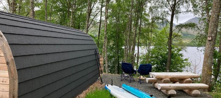 Image of glamping pod with 2 paddle boards beside it
