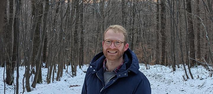 Photo of Mark Bradshaw standing in a forest looking at the camera