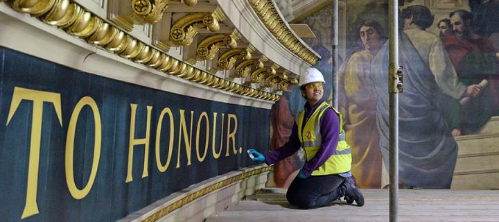 Photo of a student helping to restore paintwork in the McEwan Hall