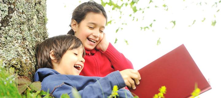 Photo of two children happily reading