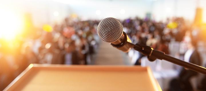 Microphone and podium facing event crowd