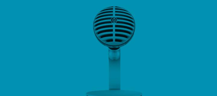 An old fashioned microphone against a blue background