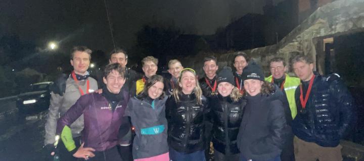 Group of cyclists pictured at night celebrating