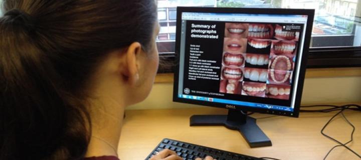 Image of dental student looking at computer screen