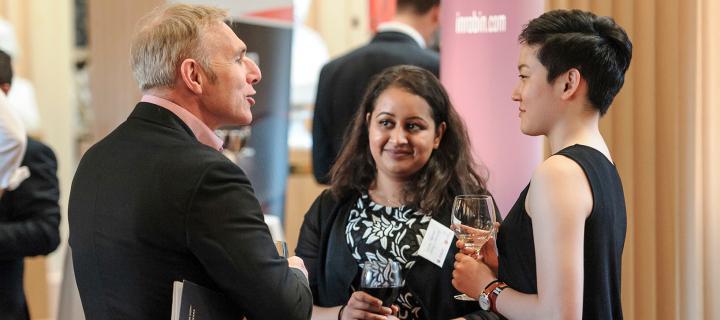 students and business leaders at a networking event