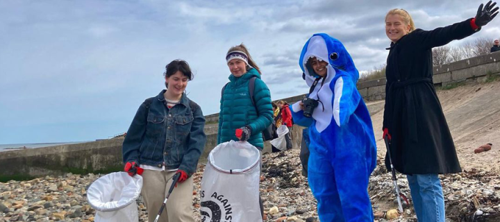 Ocean advocates student society beach clean April 2022 - four students with litter bags, one dressed as shark