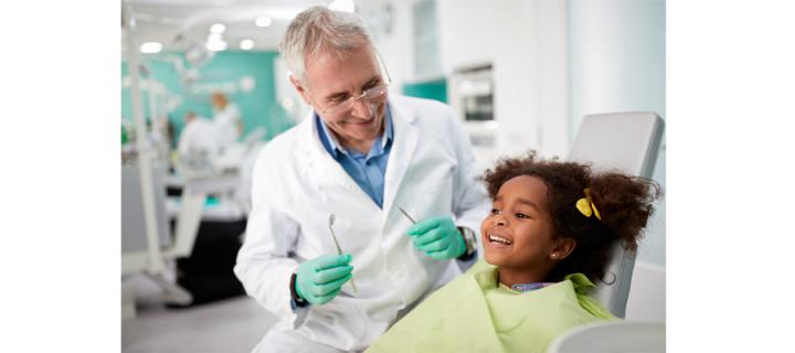 male dentist and girl patient during dental treatment