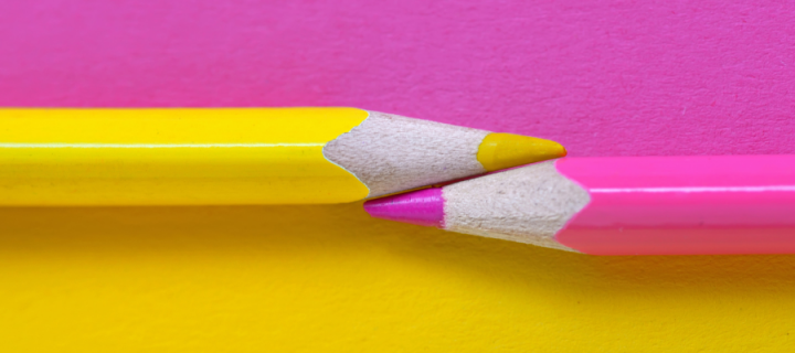 Pink and yellow pencils against a pink and  yellow background