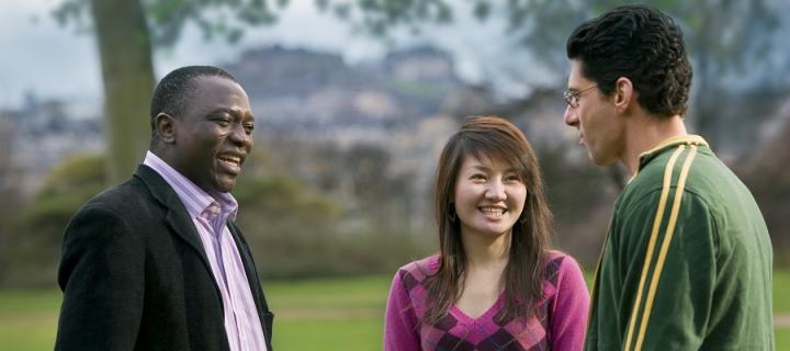 3 postgraduate students talking in the Meadows