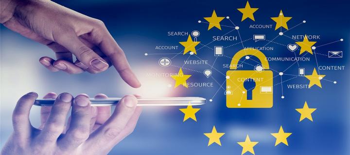 Image of a hand using a mobile device with a padlock and european union stars