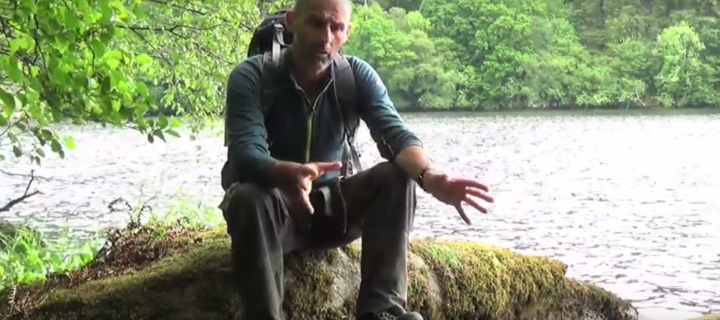 A film still of Teaching Fellow Rob Thomas by a river where beavers have recently been reintroduced.