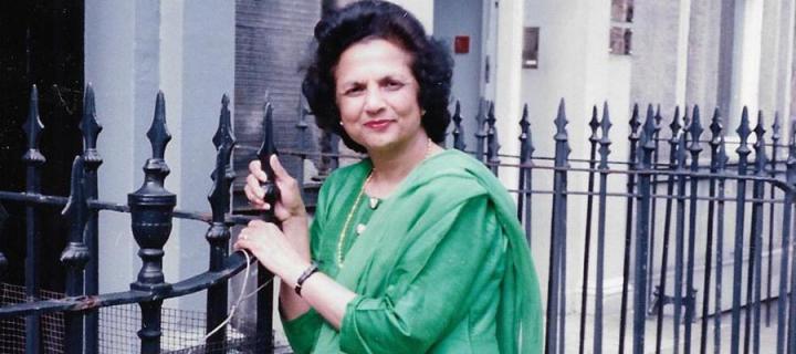 Saroj Lal wearing a green sari standing by railings on Forth Street