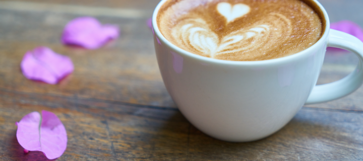 A cup of coffee with a foam heart
