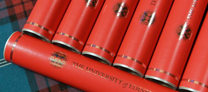Diploma scrolls sitting on University tartan