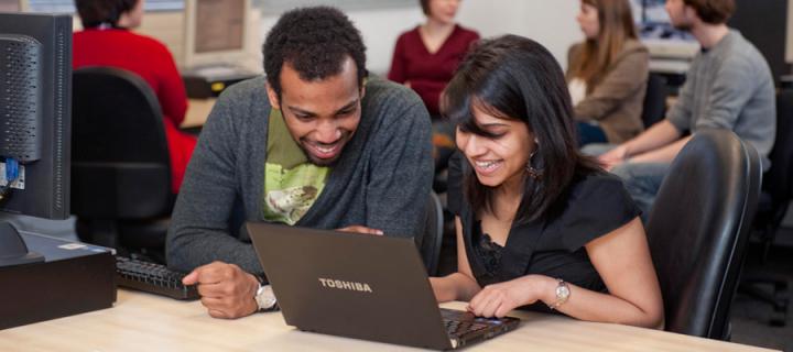 Two students sharing a laptop