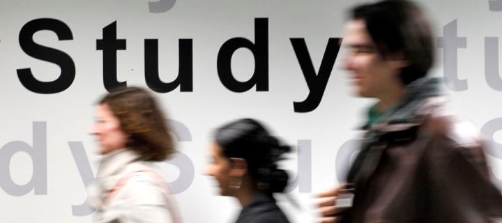 An image of students walking past a wall with the wording 'Study' on it