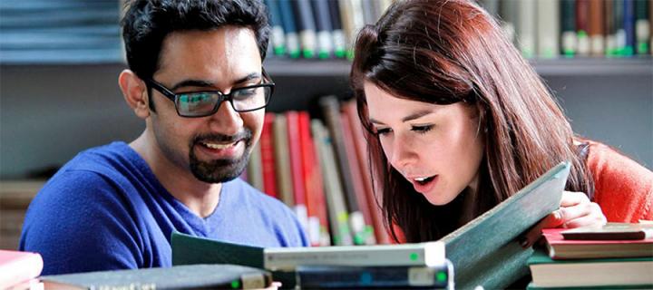 Two students reading a book