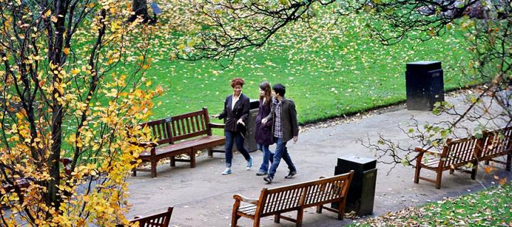 Photo of students walking through Princes Street Gardens below Edinburgh Castle.