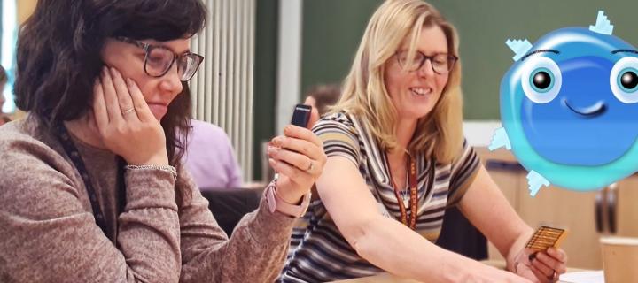 Two teachers playing the supercytes card game