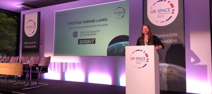 Kristine Tamane presents on stage at UK Space Conference 2019