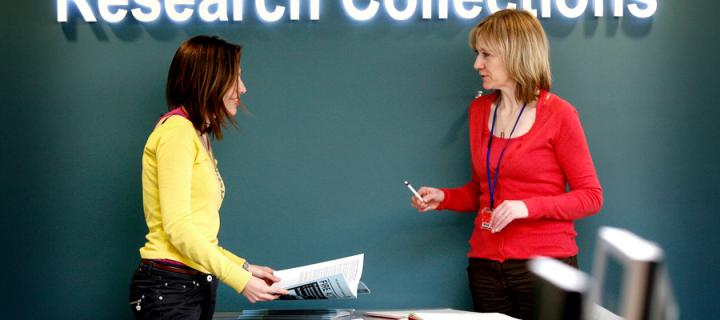 A member of staff helping a student at the Centre for Research Collections.