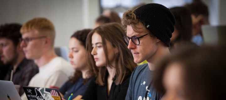 Colour photo of a School of Divinity student thinking in the Elizabeth Templeton Lecture Theatre