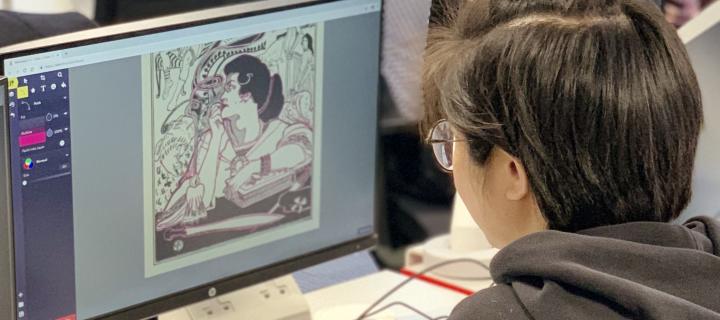 Student creating a digital illustration, looking at their computer monitor