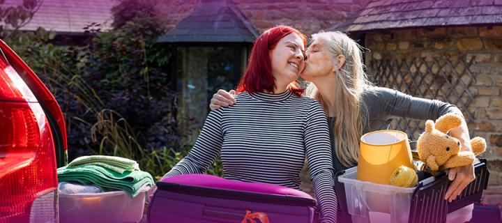 Image of a Mum kissing her daughter whilst helping her move to University