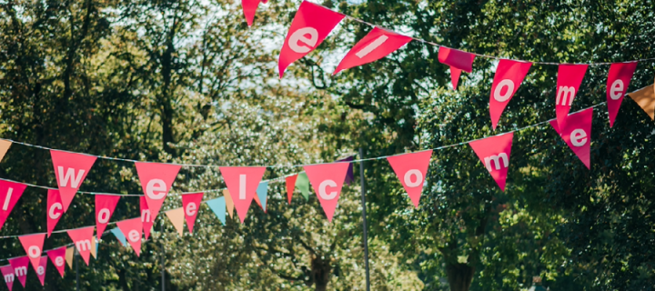 Pink Welcome Week bunting with trees in the backgound