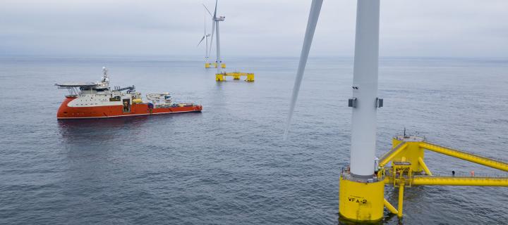 image of wind turbines mounted in ocean 