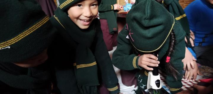 Children in school uniforms taking part in a workshop