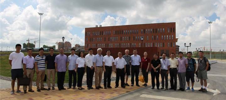 ZJU and UoE staff standing outside the gate to the Zhejiang campus