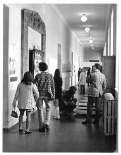 Visitors to Strategy: Get Arts (1970) inspecting work along the first-floor south corridor (from E.22 to E.25). Photo