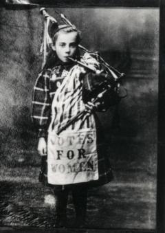 Image of Bessie Watson (aged 9) playing the pipes.