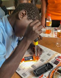 Young man disassembles a solar-powered device