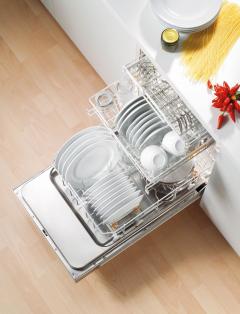 A photo of an open dishwasher. Inside the dishwasher is full of plates and cups.