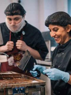 Harry Specters founder Mona Shah making chocolates with a colleague.