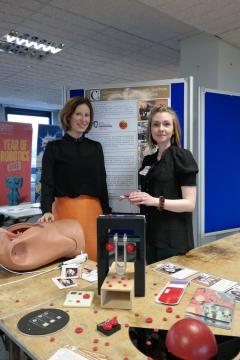 Dr Helen Szoor-McElhinney and Dr Melanie Jimenez (University of Glasgow) stand with some public engagement items
